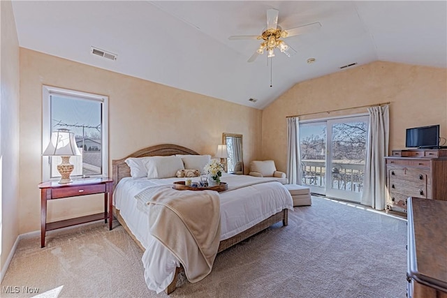 bedroom featuring access to exterior, light colored carpet, visible vents, and lofted ceiling