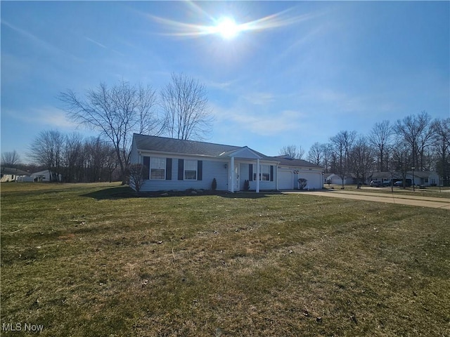 single story home with concrete driveway, a front yard, and a garage