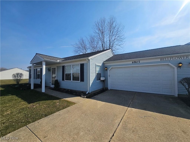 ranch-style house with a front lawn, an attached garage, and driveway