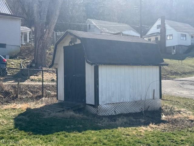 view of shed featuring fence