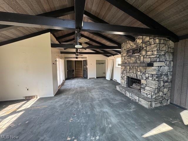 unfurnished living room featuring a fireplace, vaulted ceiling with beams, and wooden ceiling