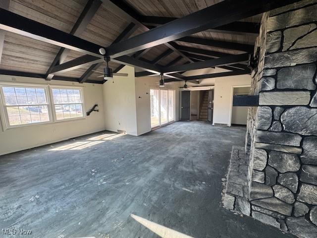 unfurnished living room with wooden ceiling and vaulted ceiling with beams