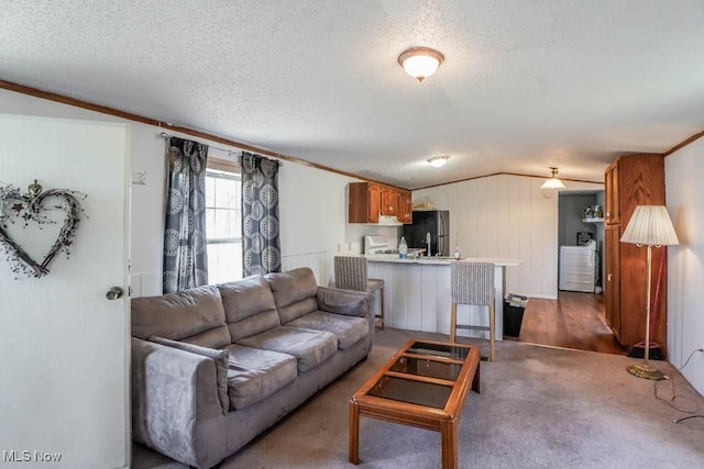 living room with a textured ceiling, crown molding, and lofted ceiling