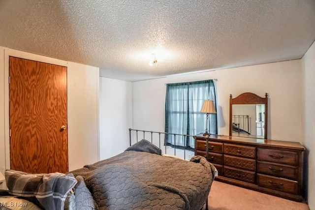 bedroom with carpet and a textured ceiling