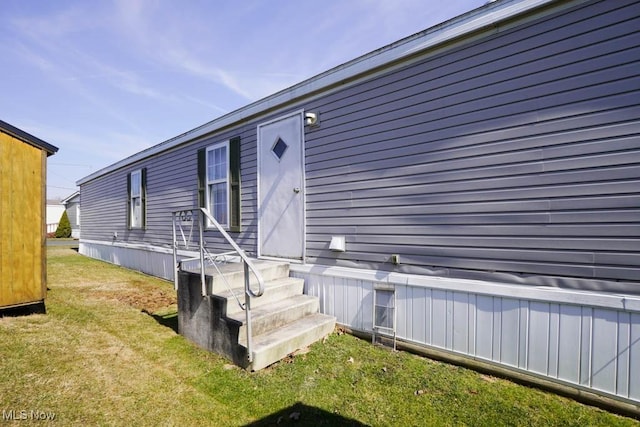 property entrance with a yard