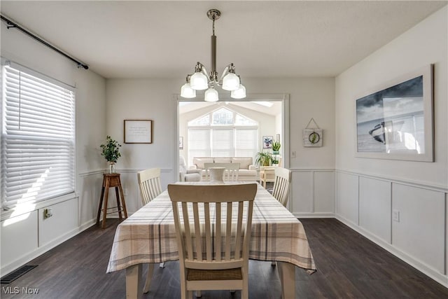 dining space with a wealth of natural light, visible vents, a notable chandelier, and dark wood-style floors