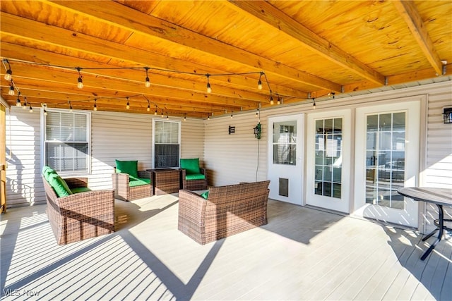 wooden terrace with an outdoor hangout area