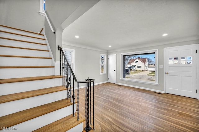 entrance foyer with stairway, recessed lighting, baseboards, and wood finished floors