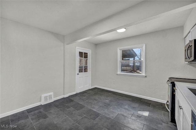 interior space with white cabinets, baseboards, visible vents, and appliances with stainless steel finishes