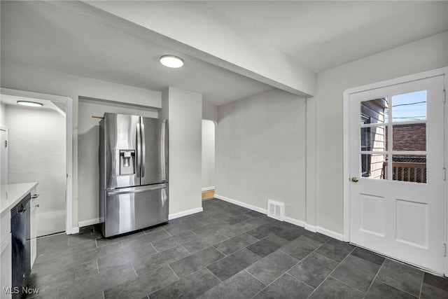 kitchen with visible vents, stainless steel fridge, dishwasher, and baseboards