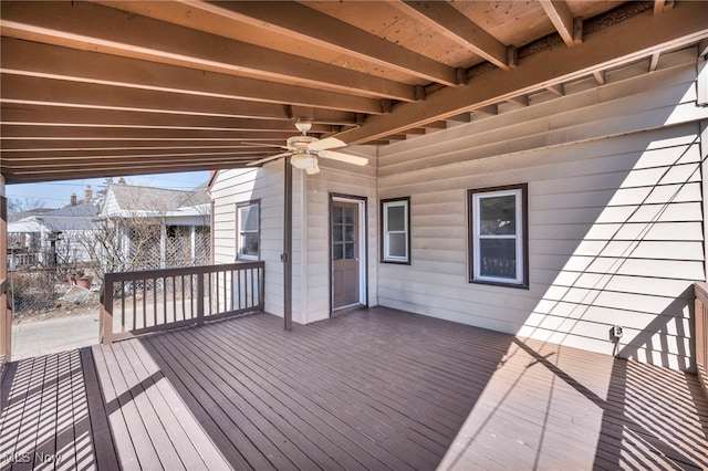 wooden deck with a ceiling fan