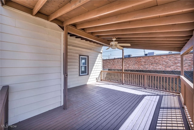 wooden terrace featuring a ceiling fan