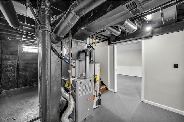 basement with gas water heater, baseboards, and visible vents