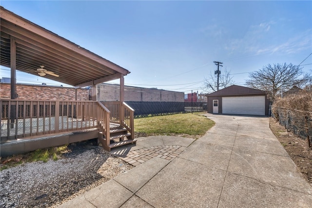 view of yard with a garage, an outdoor structure, and fence