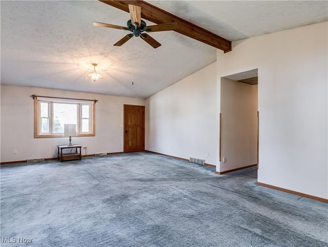 spare room featuring visible vents, baseboards, carpet, lofted ceiling with beams, and a textured ceiling