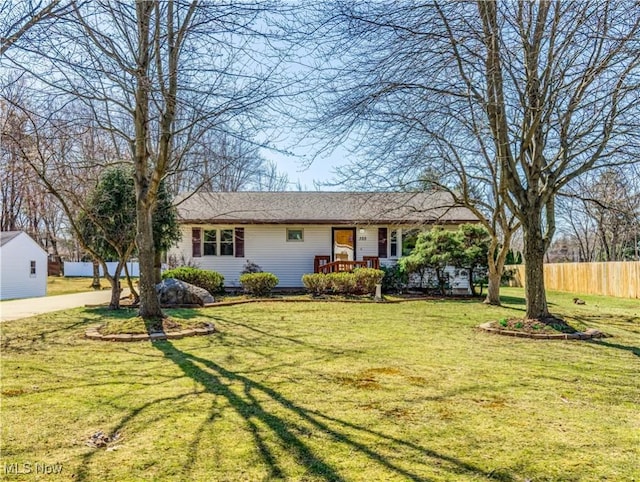 ranch-style house with a front lawn and fence