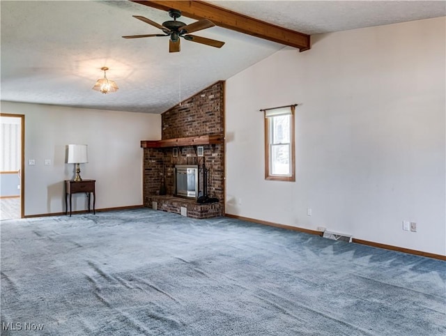 unfurnished living room featuring visible vents, vaulted ceiling with beams, a fireplace, ceiling fan, and carpet flooring