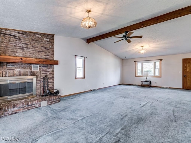 unfurnished living room featuring lofted ceiling with beams, a textured ceiling, carpet flooring, baseboards, and a brick fireplace