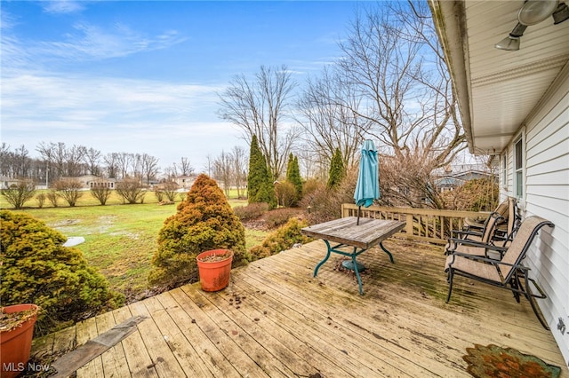 wooden deck featuring a lawn