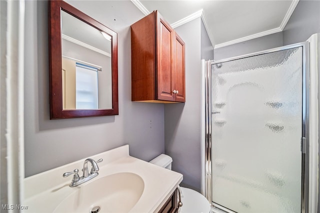 full bath with vanity, toilet, a stall shower, and ornamental molding