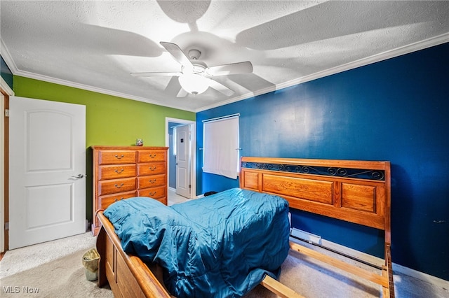 bedroom featuring a textured ceiling, crown molding, a ceiling fan, and carpet floors