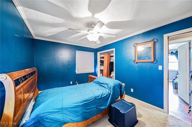 bedroom with carpet flooring, a textured ceiling, and crown molding