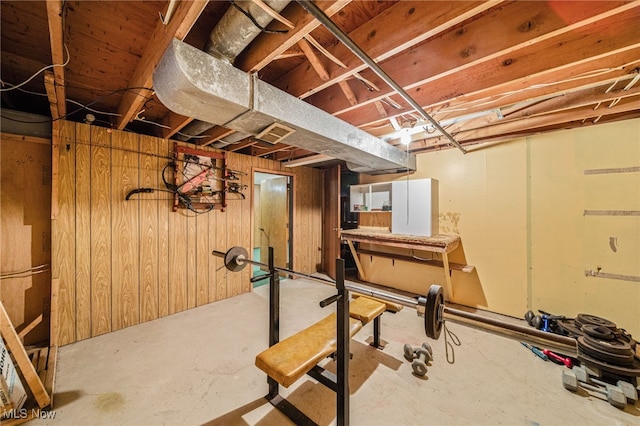 workout area featuring wood walls