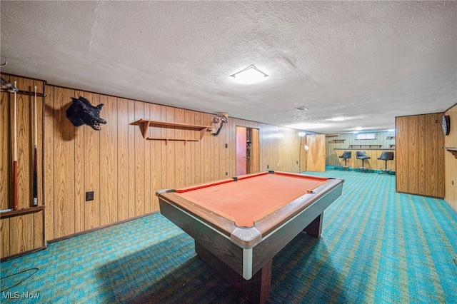 recreation room featuring wooden walls, a textured ceiling, billiards, and carpet