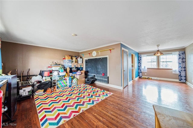 game room featuring crown molding, wood finished floors, and baseboards