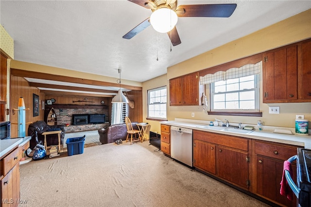 kitchen with a sink, light countertops, light carpet, dishwasher, and open floor plan