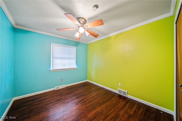 empty room featuring visible vents, wood finished floors, ornamental molding, and a ceiling fan