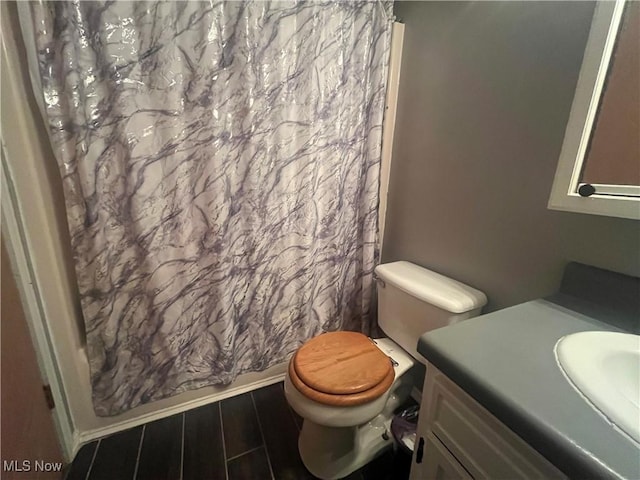 bathroom with toilet, vanity, a shower with shower curtain, and wood tiled floor