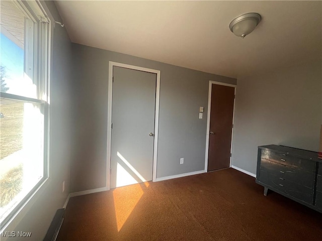 unfurnished room featuring baseboards and carpet floors