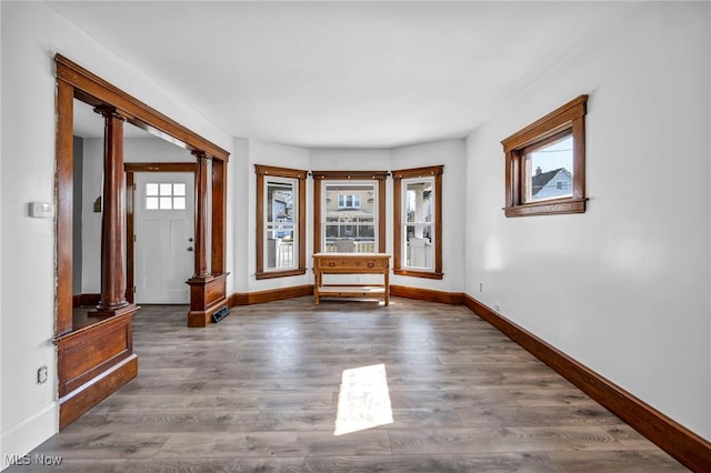 foyer entrance featuring baseboards and wood finished floors