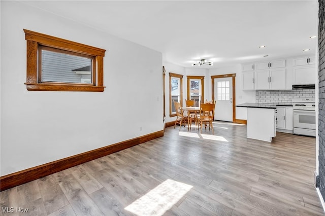 interior space featuring recessed lighting, baseboards, and light wood-style floors