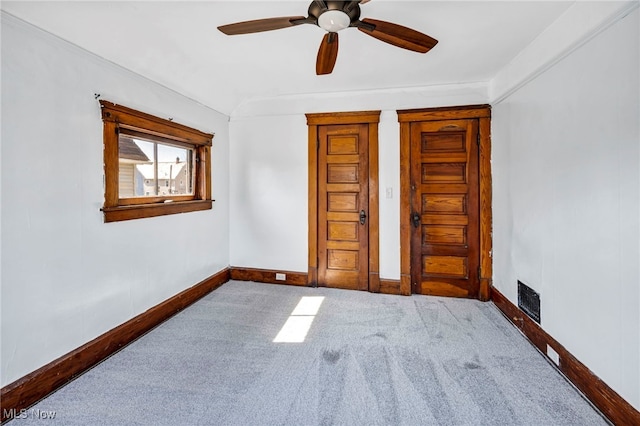 unfurnished bedroom with carpet flooring, baseboards, visible vents, and ceiling fan