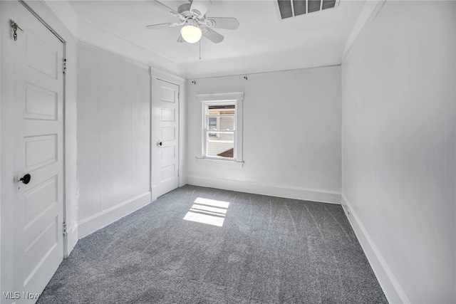 unfurnished bedroom featuring a ceiling fan, baseboards, visible vents, and carpet floors