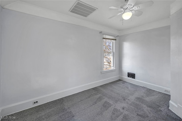 carpeted empty room featuring visible vents, baseboards, and ceiling fan