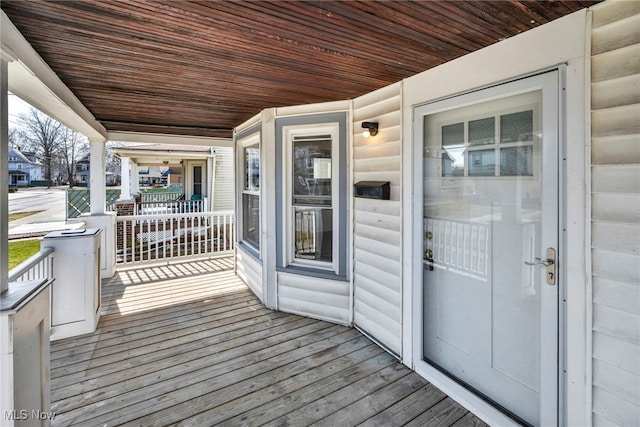 wooden terrace featuring covered porch