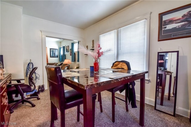 dining space with baseboards, carpet, and ornamental molding