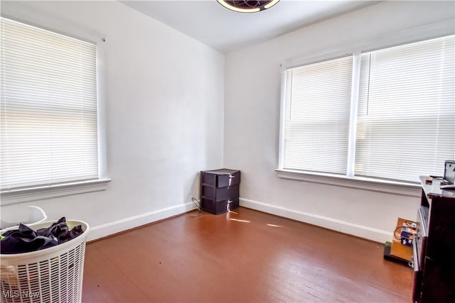 interior space featuring baseboards and wood finished floors