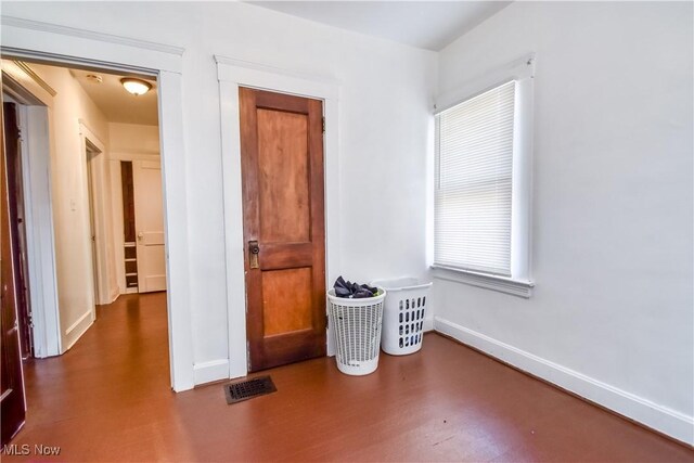 interior space featuring visible vents, baseboards, and wood finished floors