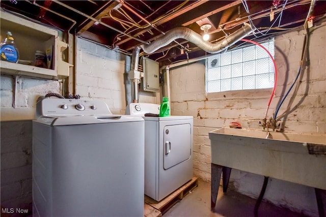 clothes washing area with electric panel, laundry area, and separate washer and dryer