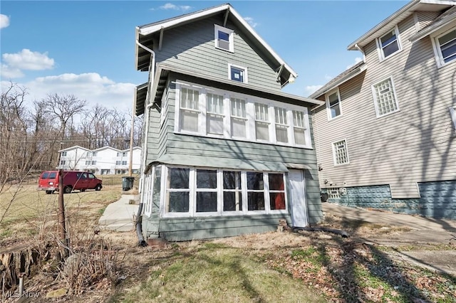 back of property with a sunroom