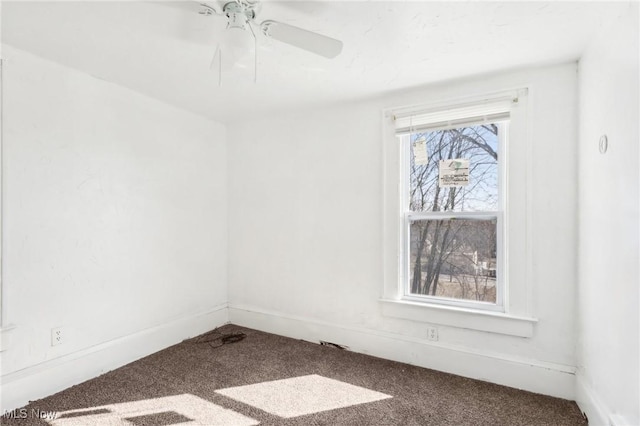 unfurnished room with baseboards, a ceiling fan, and carpet flooring