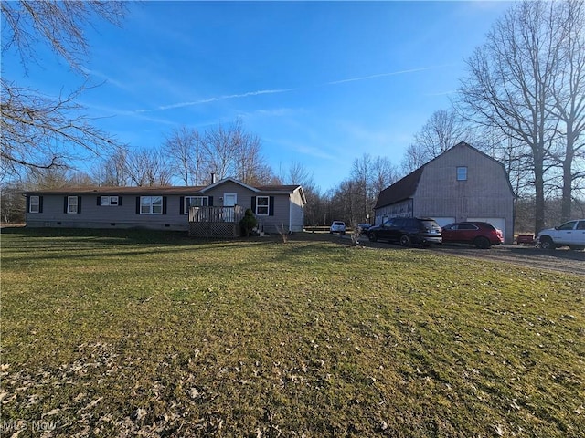 view of front facade with a garage, a front lawn, a barn, an outdoor structure, and crawl space