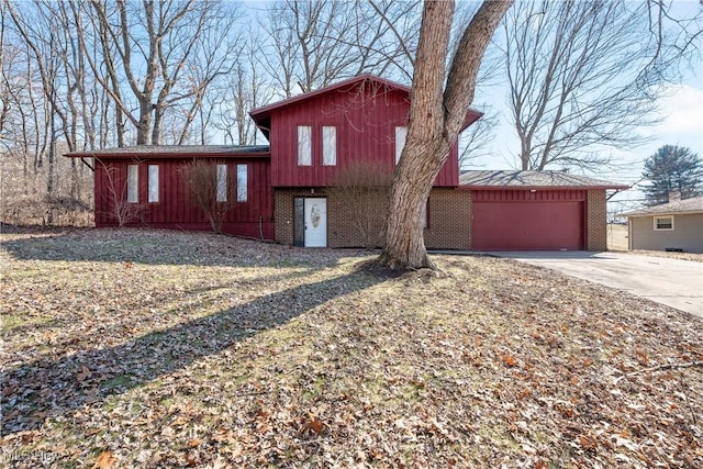 split level home with brick siding and a garage