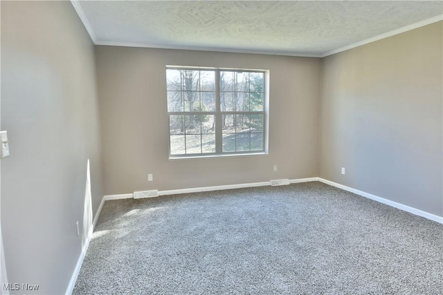 carpeted empty room with visible vents, baseboards, and a textured ceiling