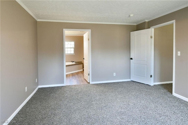 unfurnished room with carpet flooring, baseboards, and ornamental molding