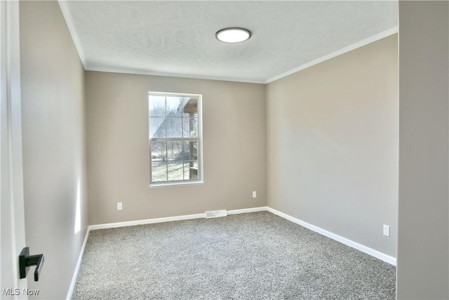 spare room with visible vents, crown molding, baseboards, carpet flooring, and a textured ceiling